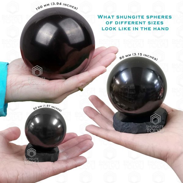black crystal ball real shungite sphere in hand