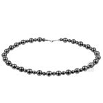Handmade black diamond bead necklace on textured background