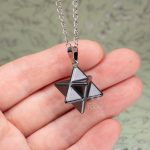 Merkaba pendant shown on hand for size reference
