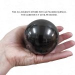 Polished stone sphere in hand