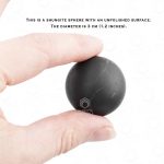 Small black sphere with natural mineral patterns