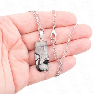 Elite shungite pendant necklace worn on hand